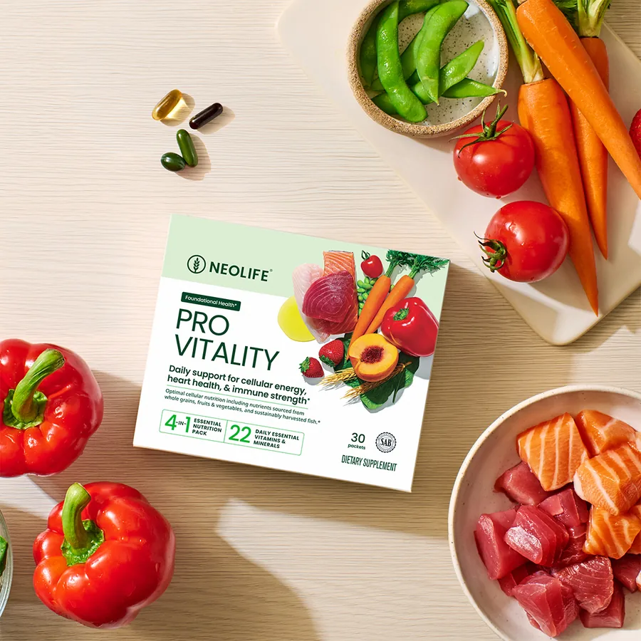 NeoLife Pro Vitality box on a wooden table with salmon, tuna, bell peppers, tomatoes, carrots and edamame